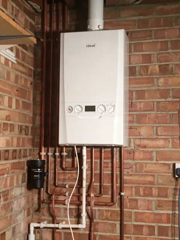 Gas boiler with isolation valves and neat copper pipework, checked during a landlord gas safety inspection