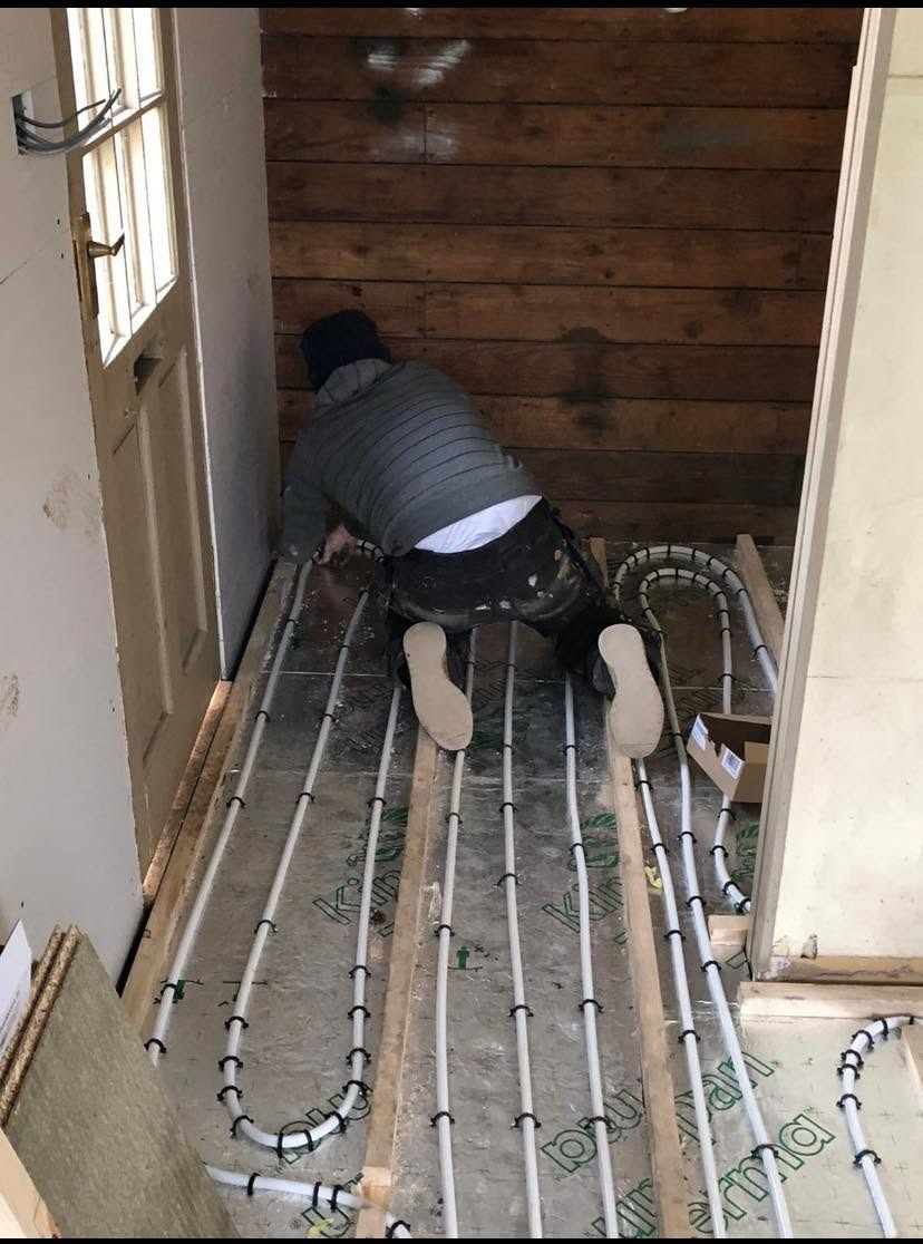 Underfloor heating pipe loops clipped to insulation boards during installation