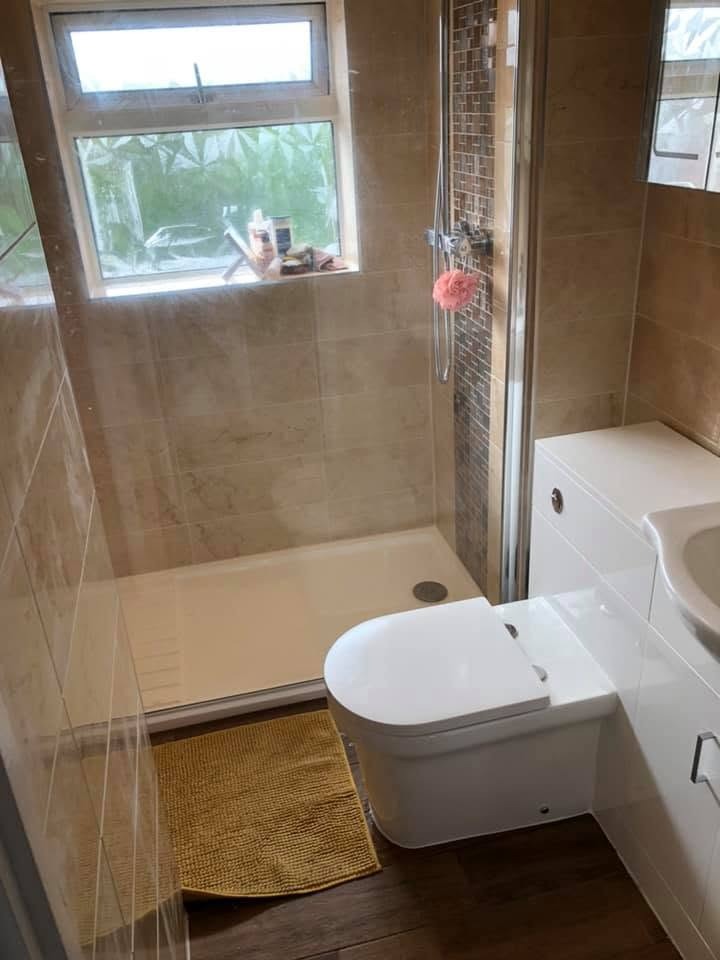Completed bathroom installation in Peterborough with a tiled walk-in shower and new WC